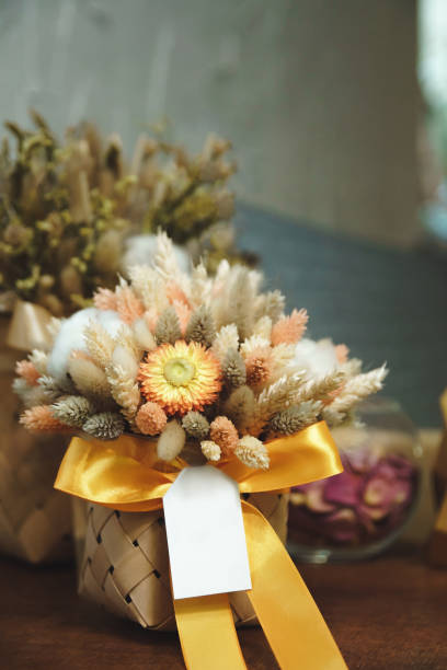 istock Dry flowers in basket with blank label. 1211090982