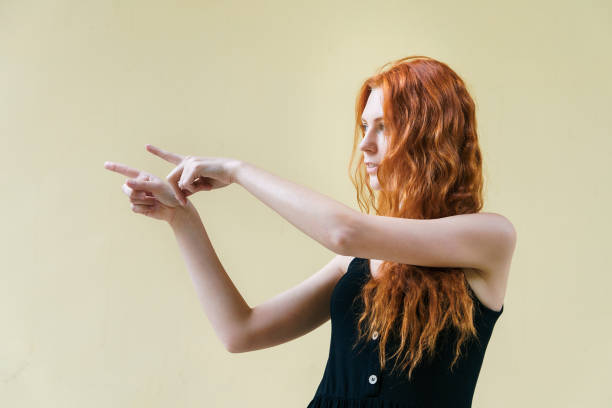 istock Young ginger woman posing on yellow background. 1211091001