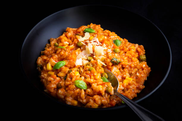 istock Risotto with tomatoes, fresh herbs and parmesan cheese 1211091010