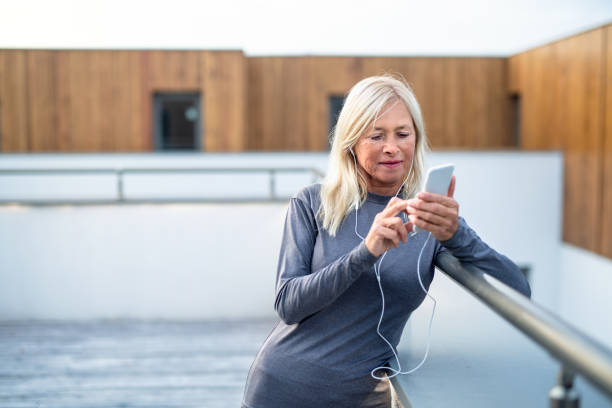 istock A senior woman with smartphone outdoors resting after exercise. 1211095158