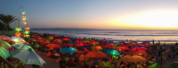 istock Chilling under beutiful beach umbrellas, Kuta, Bali 1211097477