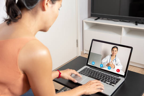 istock Woman using a laptop for a video call with a doctor 1211098201