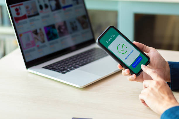 istock using smartphone and laptop online shopping 1211098233