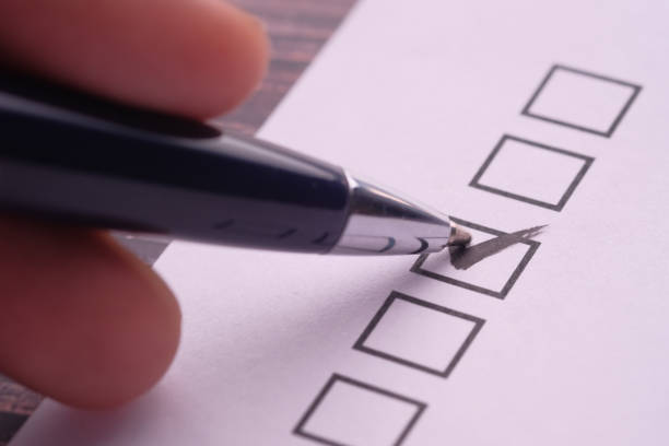 istock Close up of check mark on white paper 1211098962
