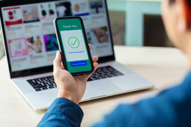 istock using smartphone and laptop online shopping 1211098979