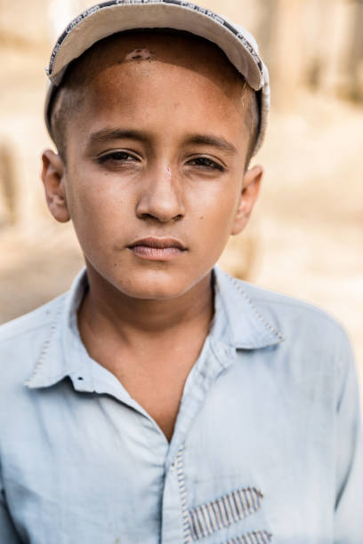 istock a young wounded boy with sad expression wearing a cap and 1211099418