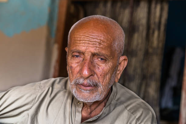 istock arab elderly man sitting inside a dark room with sad expression after loosing his homeland 1211101605