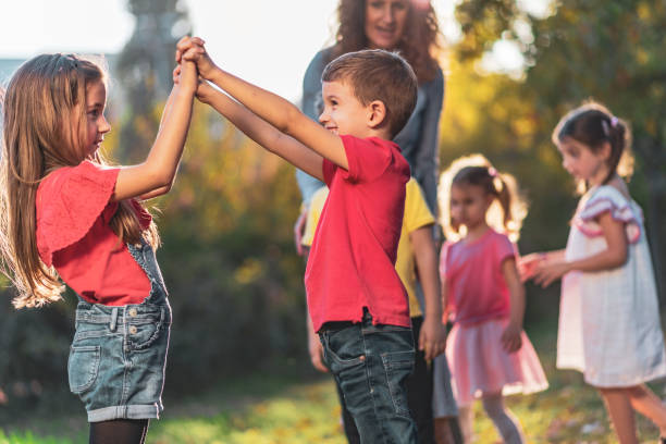istock Happy kids playing in public park 1211101616