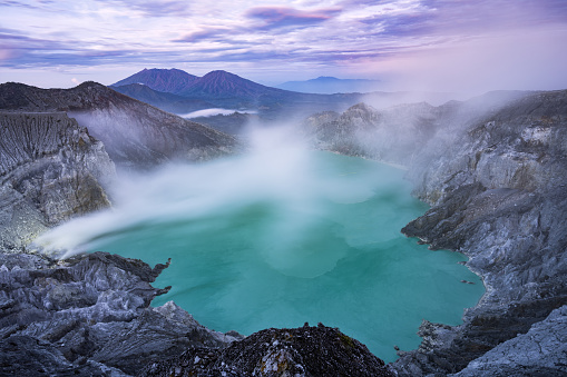 View from above, stunning view of the Ijen volcano with the turquoise-coloured acidic crater lake. The Ijen volcano complex is a group of composite volcanoes located in East Java, Indonesia.