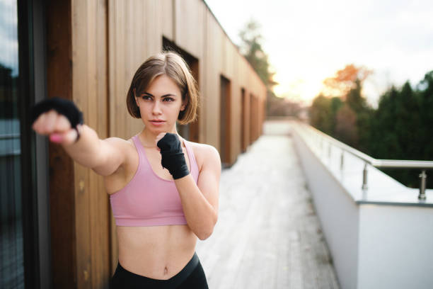 istock A young woman practising karate outdoors on terrace. 1211105112
