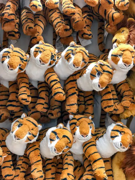 tiger dolls hang on to the wall for sales in kid depart at departmentstore.