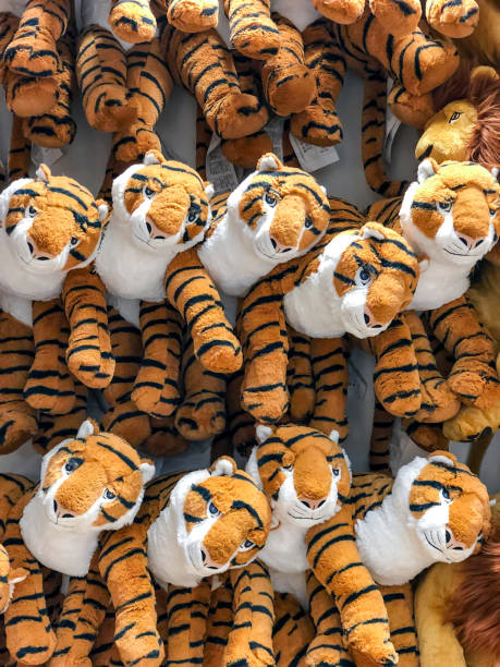 tiger dolls hang on to the wall for sales in kid depart at departmentstore. - depart imagens e fotografias de stock