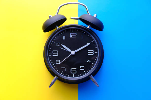 istock top view of alarm clock on color background 1211107907