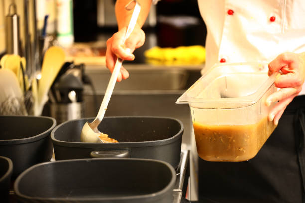 istock professional cook in kitchen preparing food for customers showing 1211108179