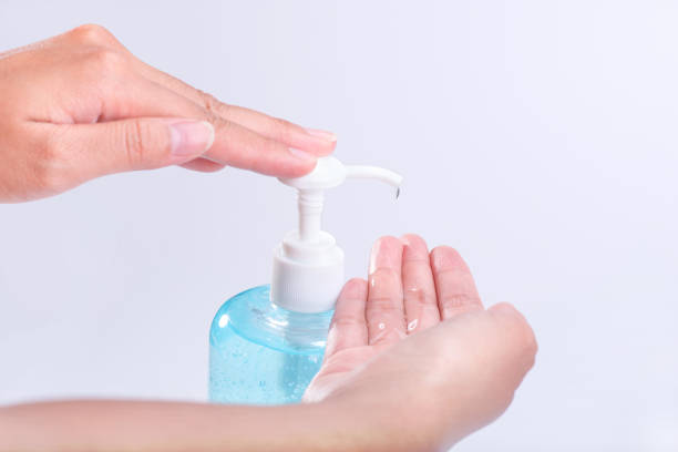 Hand with alcohol hand wash gel for protection anti becteria and protect from Coronavirus Disease COVID-19 isolated on white background stock photo
