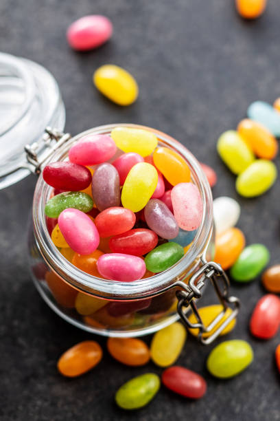 Fruity jellybeans. Tasty colorful jelly beans. Fruity jellybeans. Tasty colorful jelly beans in glass jar. candy jellybean variation color image stock pictures, royalty-free photos & images