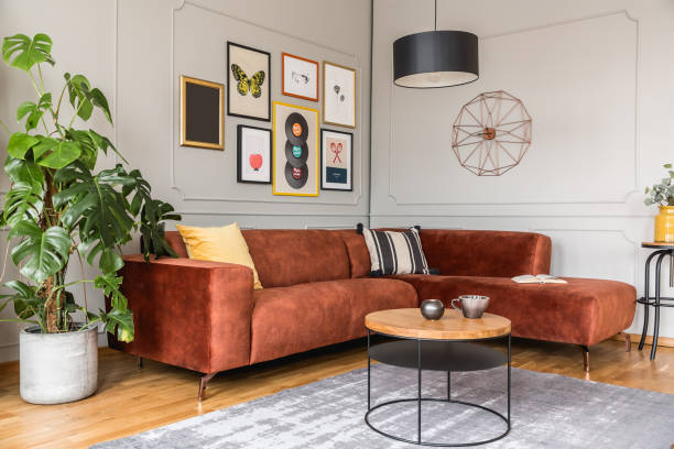 istock Eclectic living room interior with comfortable velvet corner sofa with pillows 1211109323