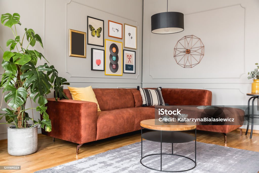 Eclectic living room interior with comfortable velvet corner sofa with pillows Living Room Stock Photo
