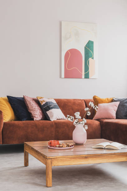 istock Comfortable brown velvet sofa with pillows in elegant living room interior 1211110441