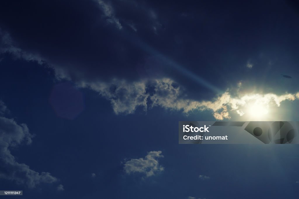 The sun shines bright in summer. Blue sky and clouds. The sun shines bright in summer. Blue sky and clouds.- image toned Backgrounds Stock Photo