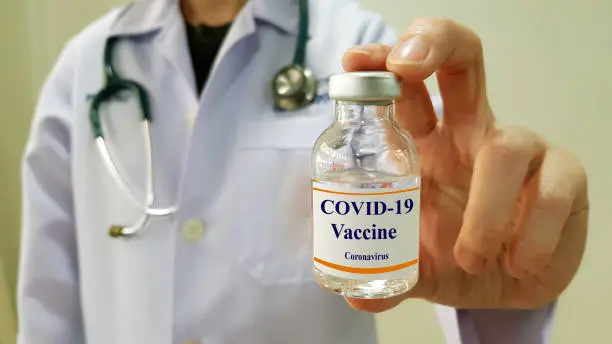 Doctor show COVID 19  vaccine for prevention and treatment new corona virus infection(COVID-19,novel coronavirus disease 2019 or nCoV 2019