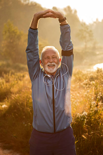 istock Senior man stretching arms outdoors 1211117166