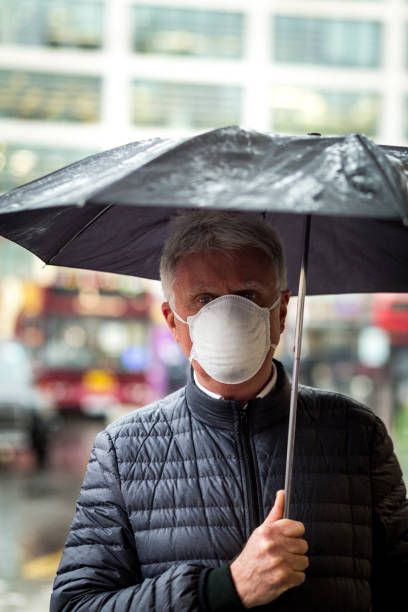 istock Senior man wearing protective face mask outdoors in the city 1211118427