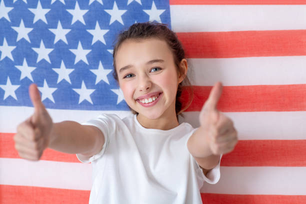 istock Smiling happy girl standing with arms outstretched. 1211120620