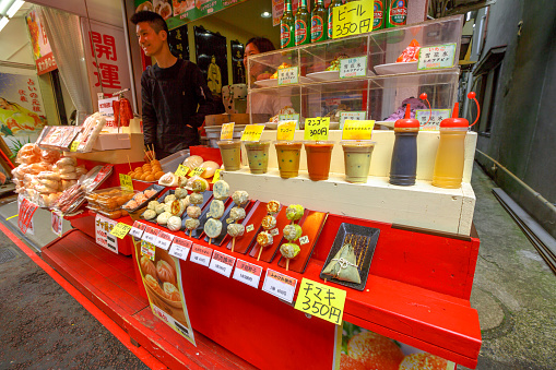 Yokohama, Japan - April 21, 2017: seller in chinese street food with fresh smoothies, typical drinks, fruit drinks, sweets, pastries in Yokohama Chinatown, the Japan's largest Chinatown.