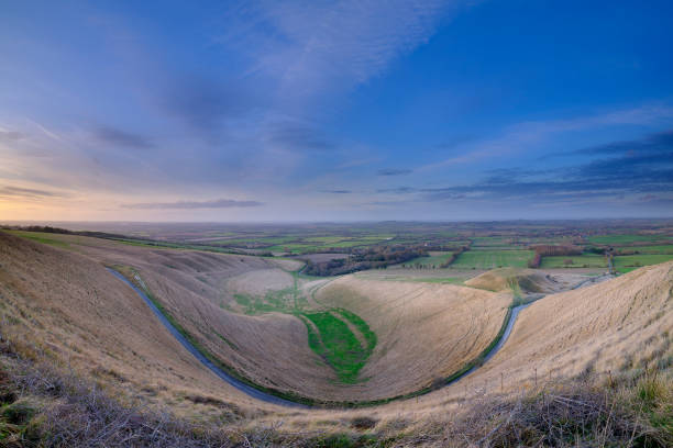Views over the White Horse at Uffington on the Ridgeway Wantage, UK - January 29, 2019:  Sunset view over the White Horse at Uffington on the hills near Lamborne Chase, UK uffington horse stock pictures, royalty-free photos & images