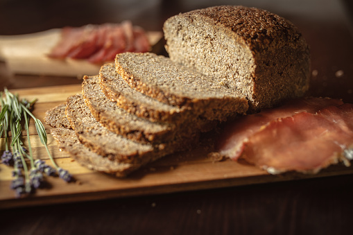 Healthy food preparation. Sandwich made with bread with whole grains served on wooden plate