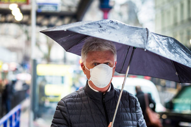 istock Senior man wearing protective face mask outdoors in the city 1211124623