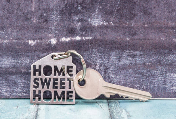 istock Keys on a keyring with a small house 1211125781