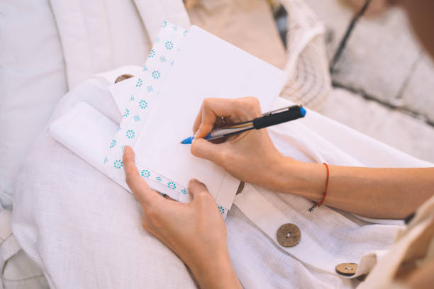 female tourist signs postcard or letter to friend from venice. - writing letter correspondence women imagens e fotografias de stock