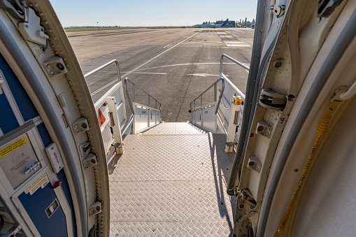 Airplane exit stairs and the clear runway