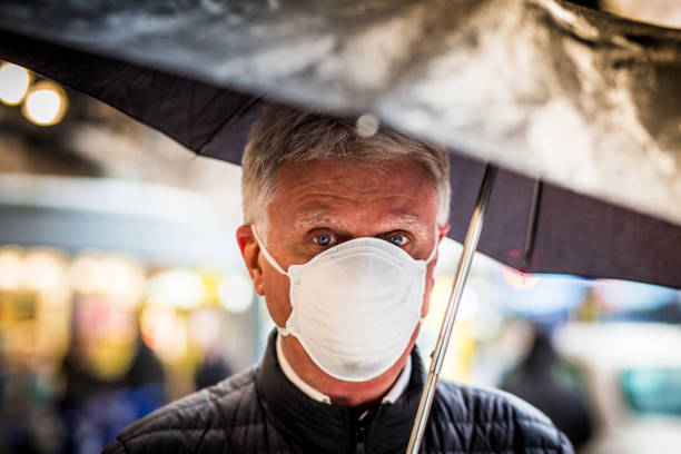 istock Senior man wearing protective face mask outdoors in the city 1211130139