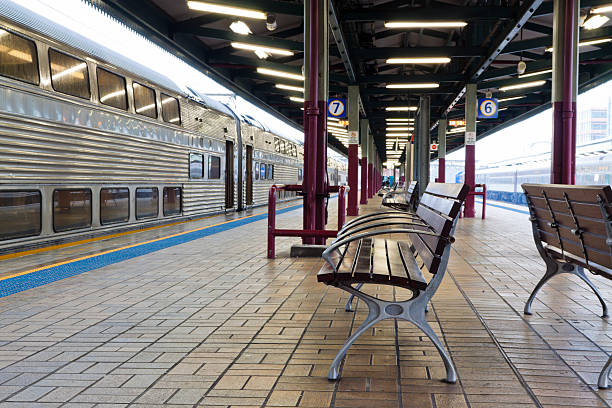 istock Train station with seats and waiting train in rainy day 121113288