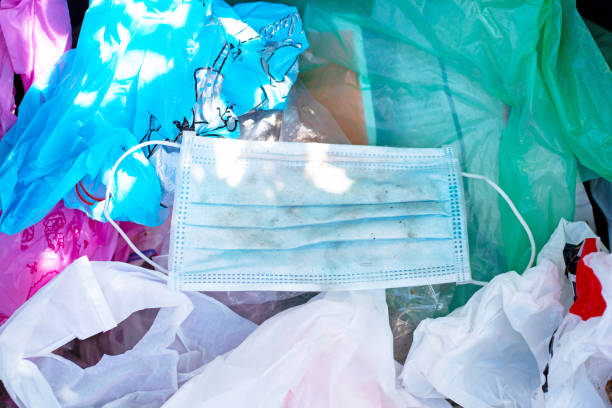 istock Dirty used surgical mask in a garbage bin. 1211137461