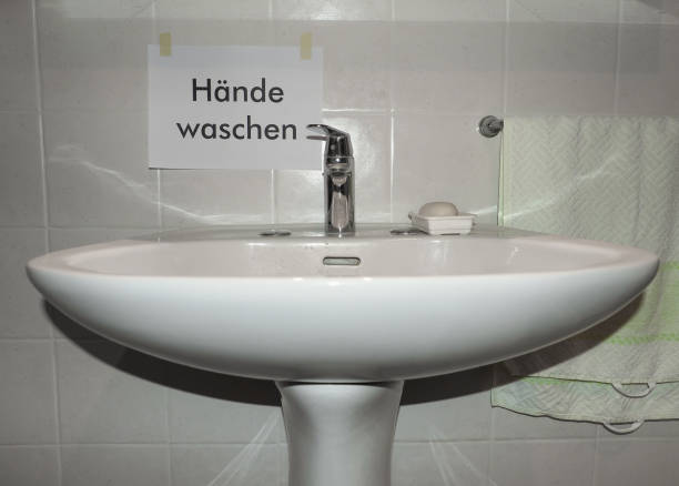 Haende waschen (translation: wash your hands) sign near bathroom basin