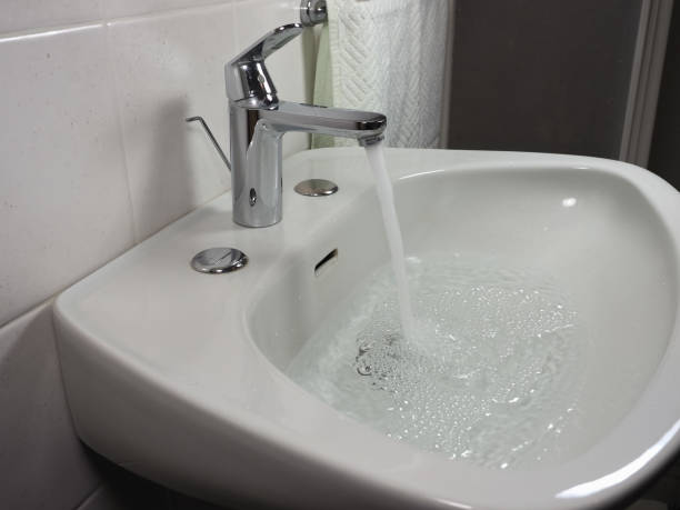 istock tap faucet in basin 1211137766