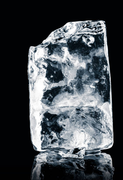 istock Crystal clear natural ice block on  black reflective surface. Clipping path included. 1211139203