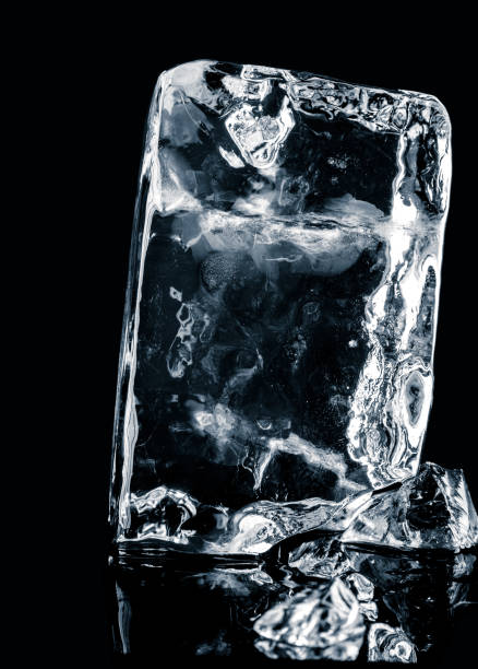 istock Crystal clear natural ice block on  black reflective surface. Clipping path included. 1211139206