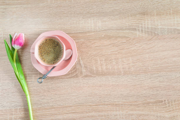 istock Romantic spring still life with cup of coffee and one tulip 1211140328