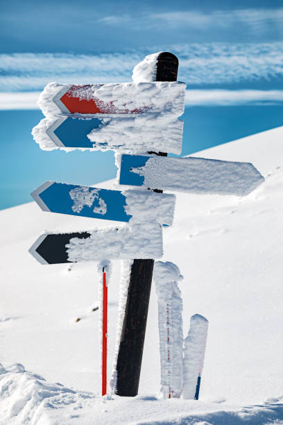 istock Blank arrow sign covered with snow 1211141478
