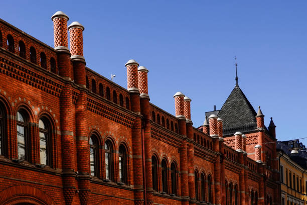 Red brick building with windows and blue sky
