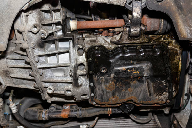 istock Car engine with gearbox mounted in the car seen from below, visible engine components. 1211143851