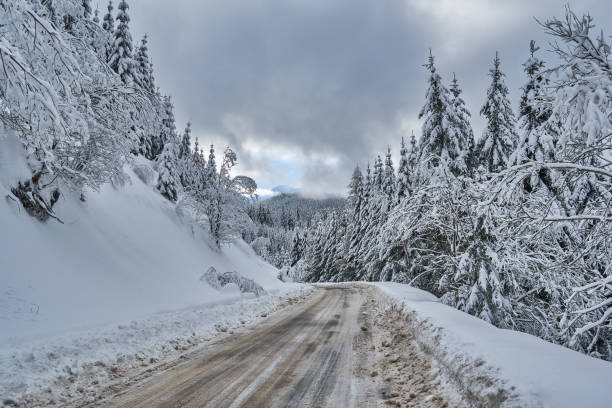 istock Winter landscape from the mountain with the road covered with snow 1211144009