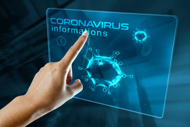 a woman's finger click information on the corona virus on a digital screen stock photo