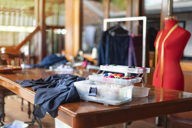 istock sewing tools and reels of color thread on table. 1211144348