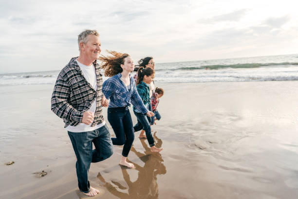 istock Family running on the beach 1211144363